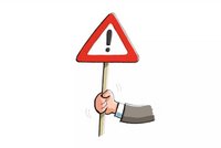 Eine Hand hält ein Warn-Schild mit einem Ausrufezeichen (leichte Sprache)
